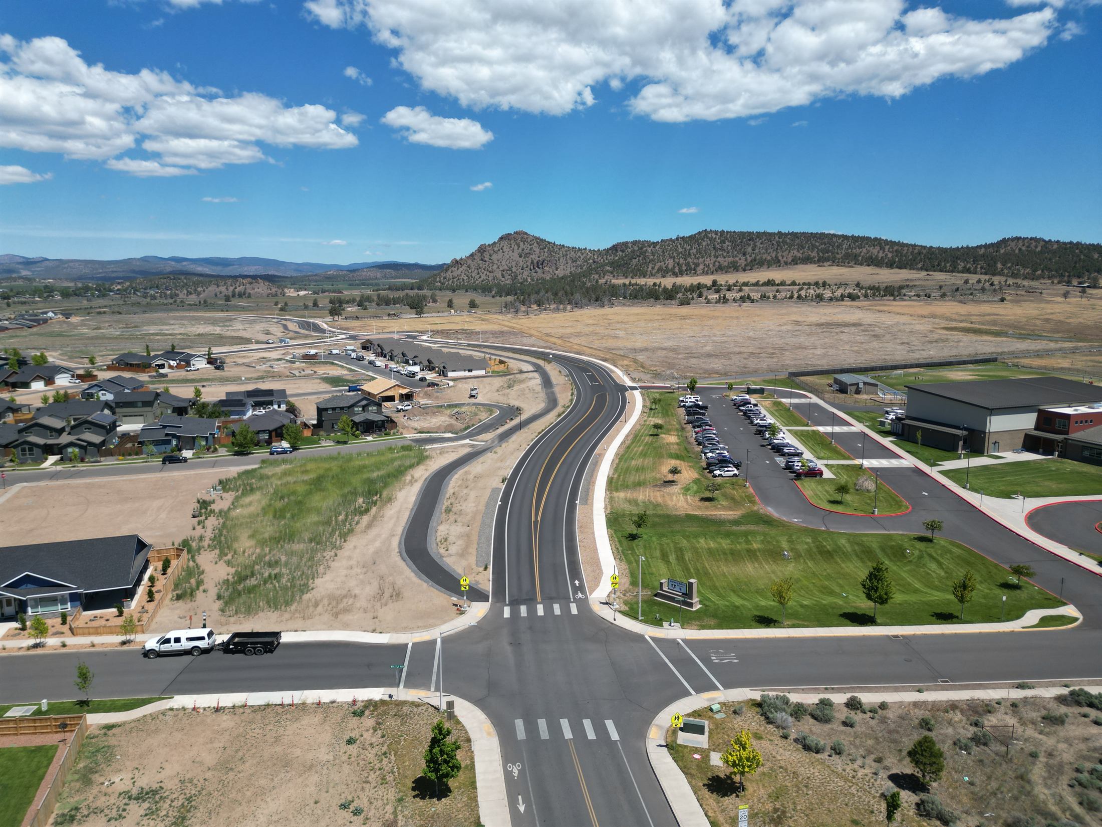 Roadway leading toward Barnes Butte with open land and community infrastructure