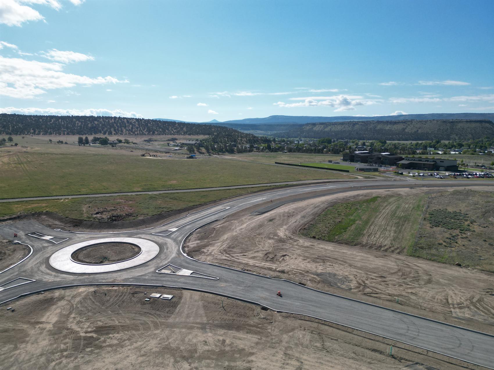 Aerial view of a roundabout and prepared development land near Barnes Butte